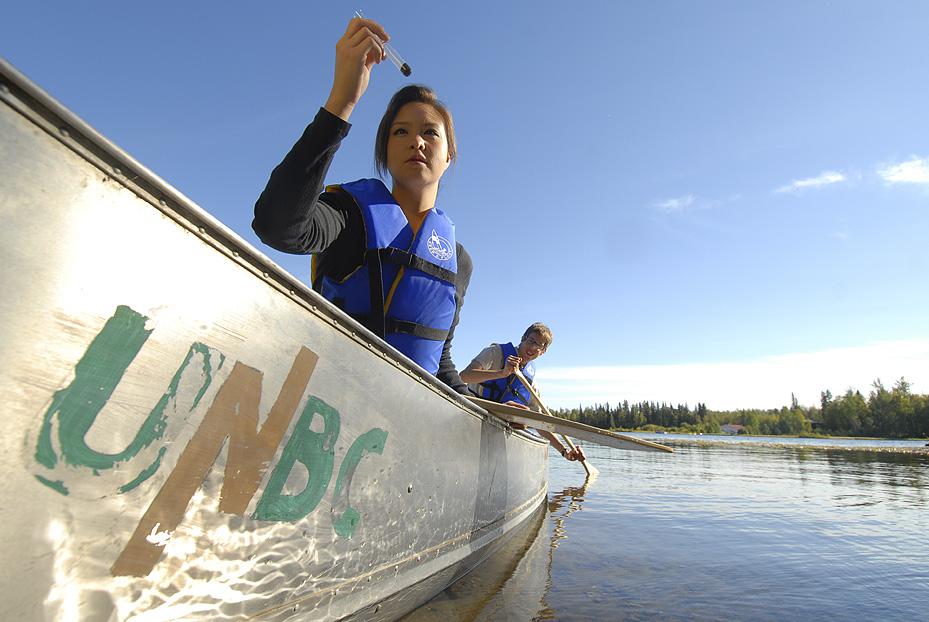 UNBC researchers in a canoe sampling water