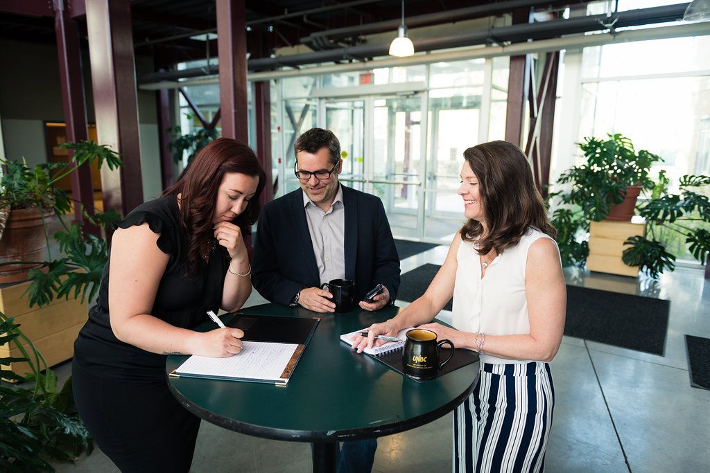 People standing at a table studying