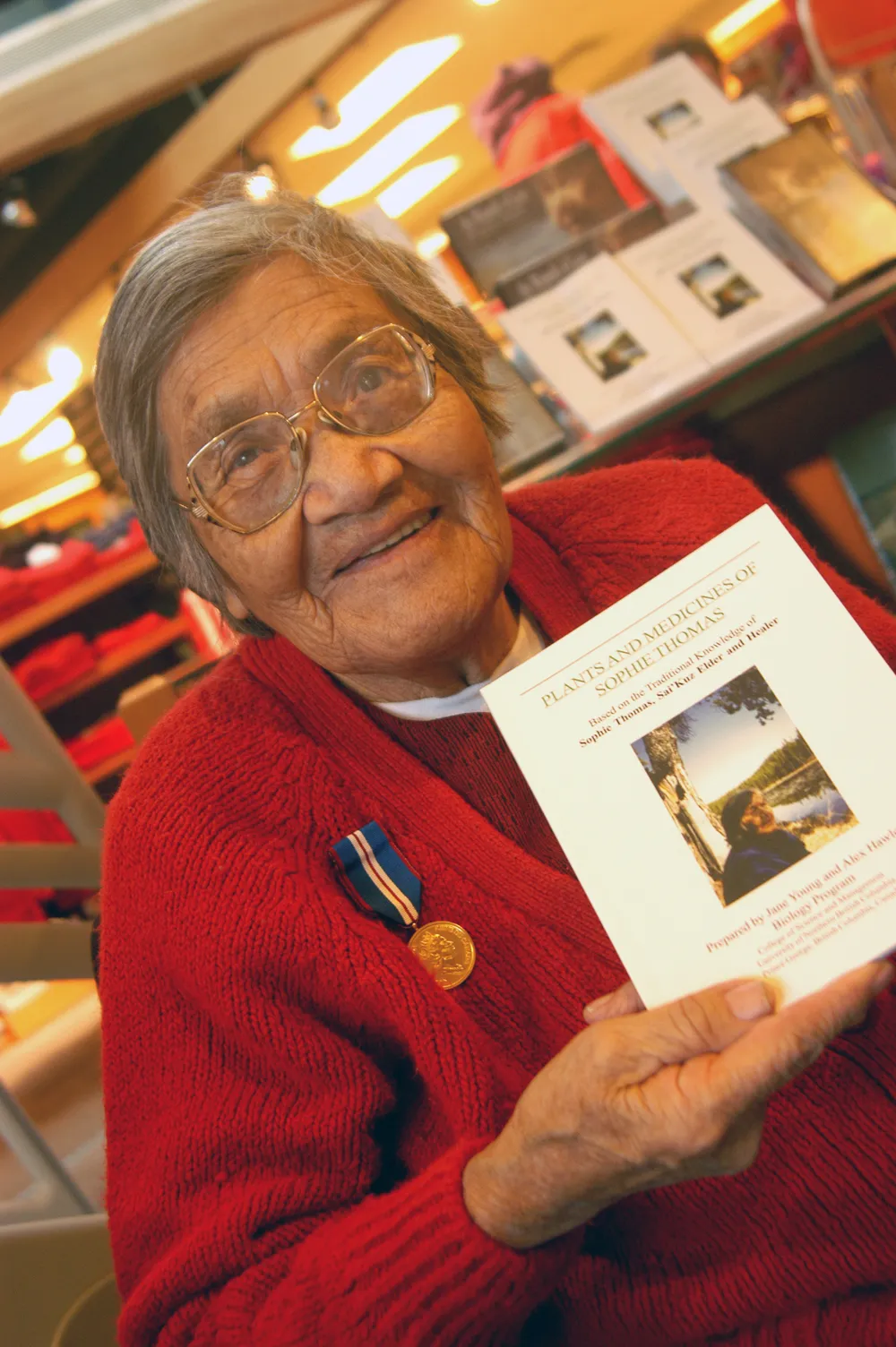 Sophie Thomas holding a copy of her book