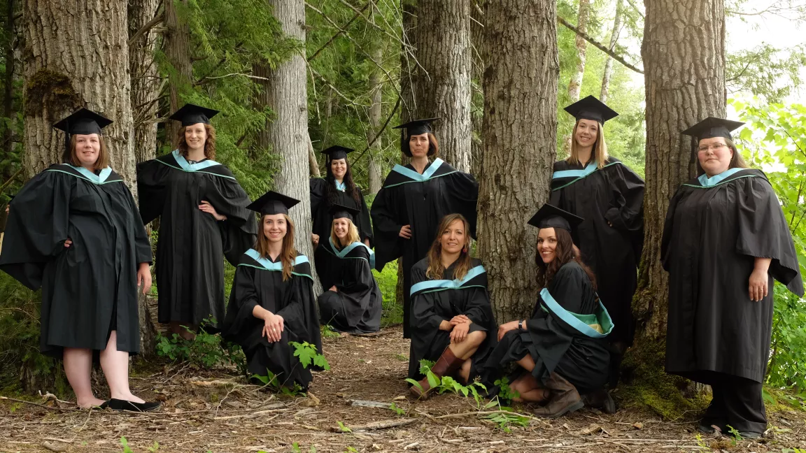 Terrace Education graduates posing in the forest on Ferry Island.