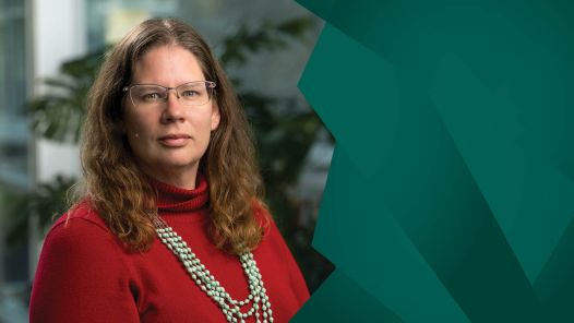 Photo with graphic shows Person wearing glasses, red sweater and turquoise necklace on left and green graphic design on right.