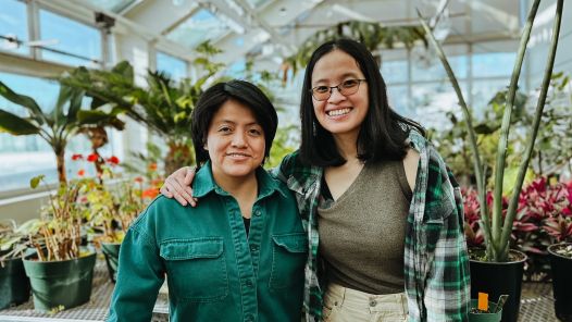 Two people in a greenhouse