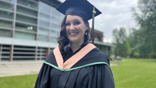 Cheri Tetreault outside the South-Central campus, in cap and gown 