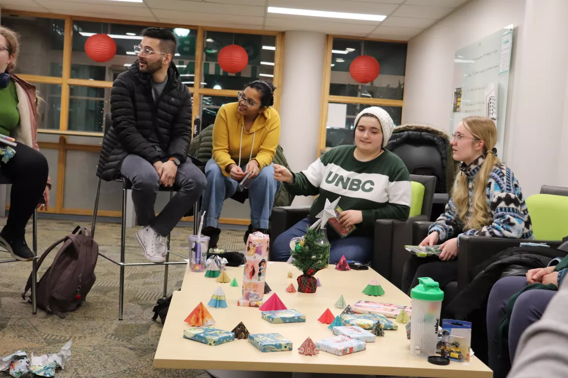 UNBC students sitting at a winter party