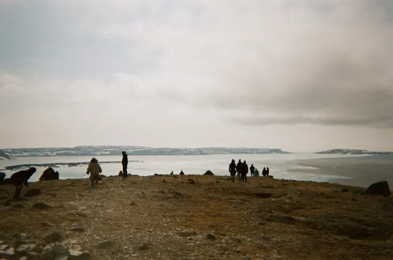 A group of researchers on a rocky northern coast.