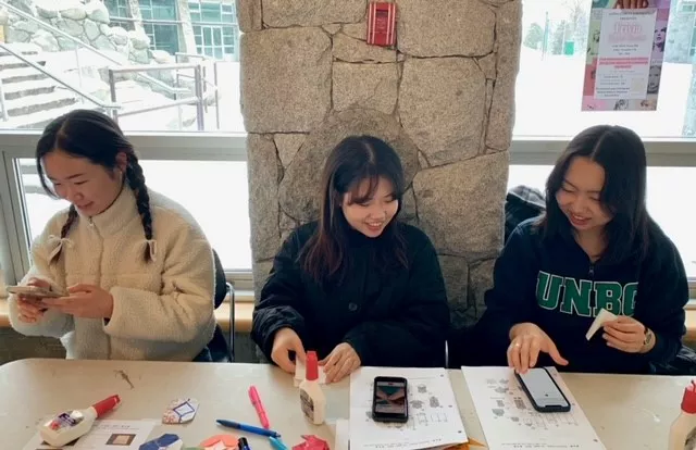 Students watching origami tutorials on YouTube