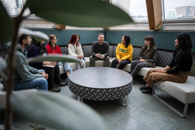 UNBC students and staff sitting at a table on campus
