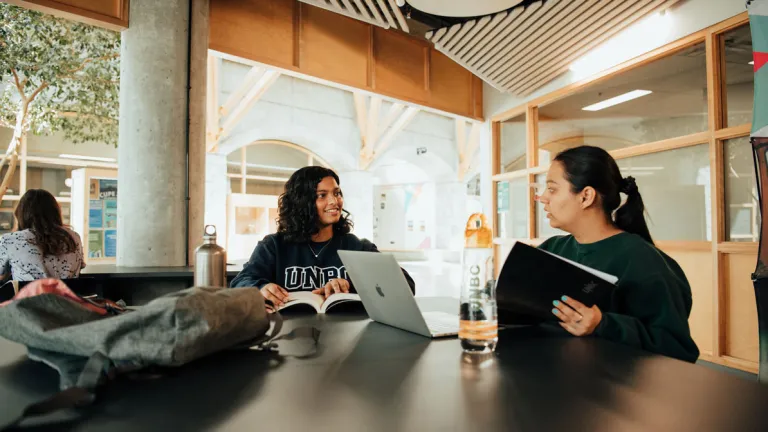 UNBC students sitting at a desk