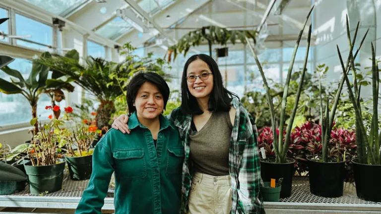 Two women in the UNBC greenhouse