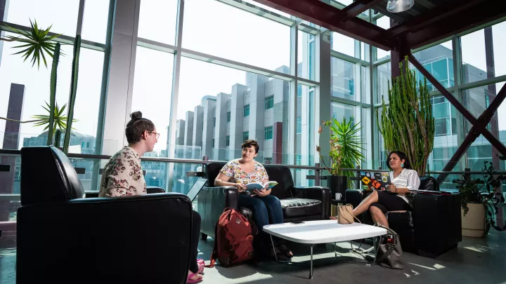 Students discussing in UNBC lounge area
