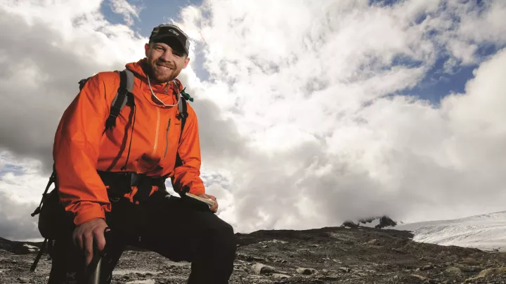 Environment Science student on a glacier doing a field study