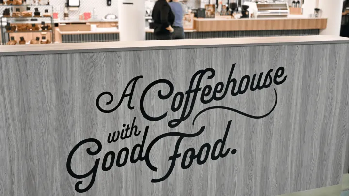 Half-wall with decal that says "A Cofeehouse with Good Food"