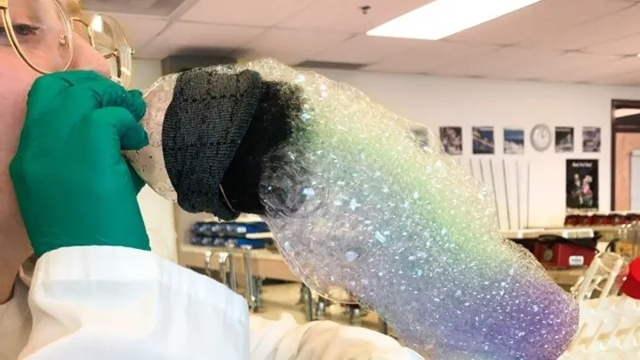 Youth blowing colourful bubbles to form a snake