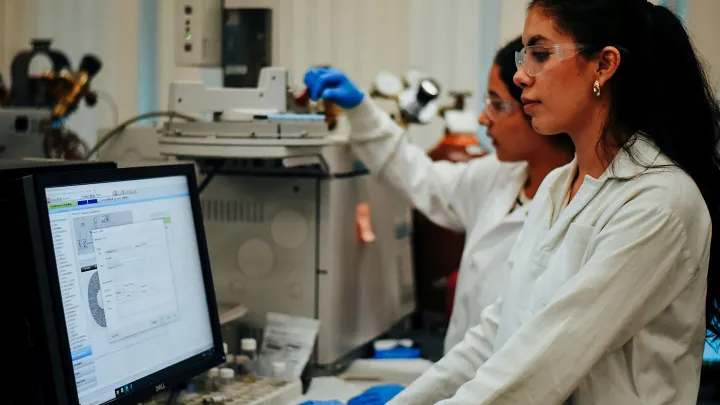 Student looking at a computer screen in a research lab