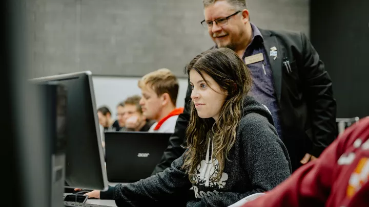 Professor and students in a computer lab