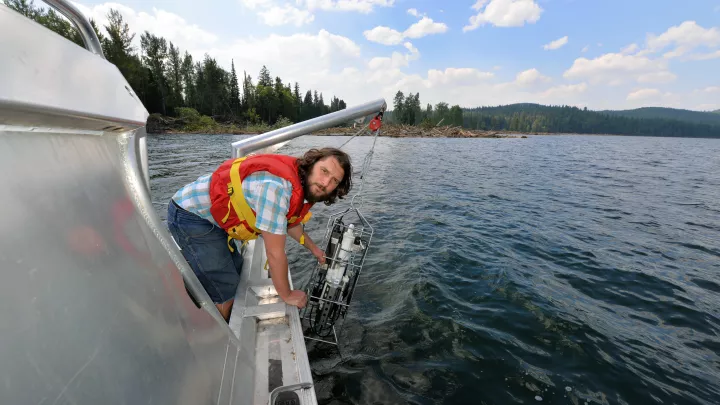 Wildlife and Fisheries student conducting a study from a boat