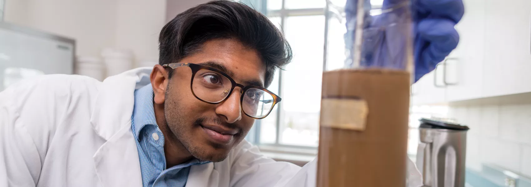 UNBC student observing something in the lab