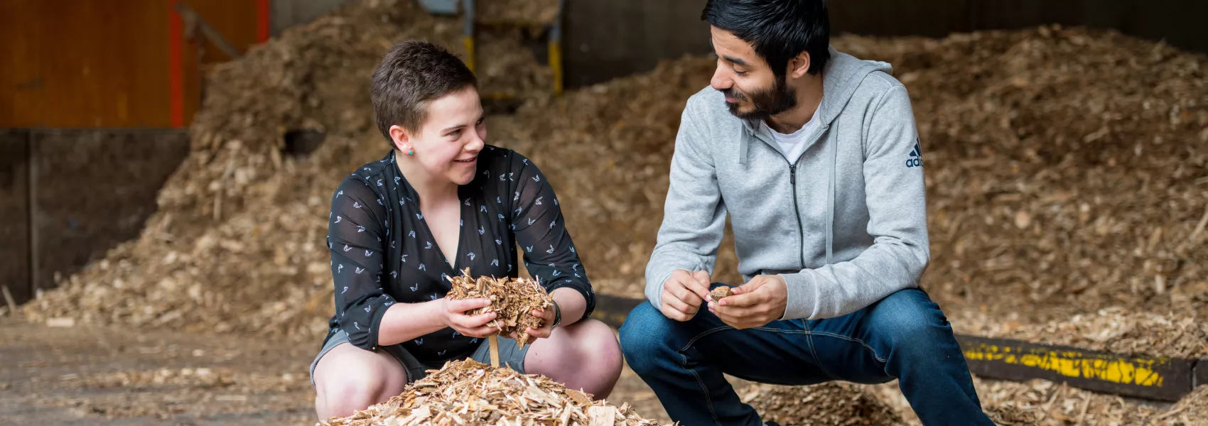 Two students examining some mulch